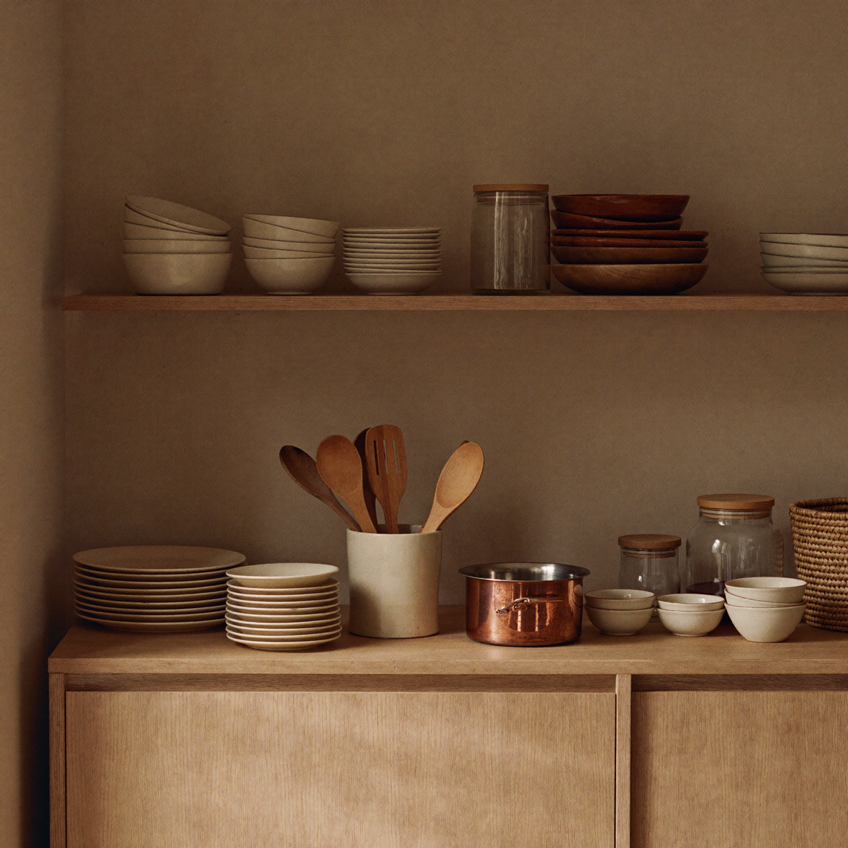 Kitchen & Storage — porcelain, glass jars, copper and seagrass against warm plaster